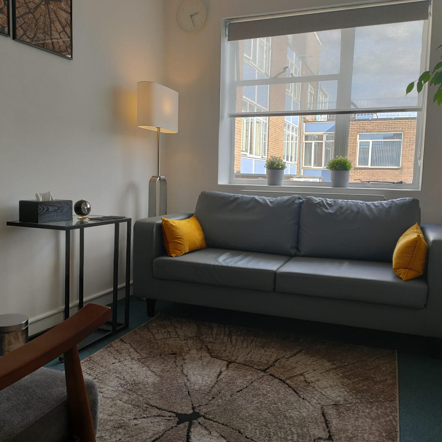 Steve's empty office with comfy sofa in front of a window